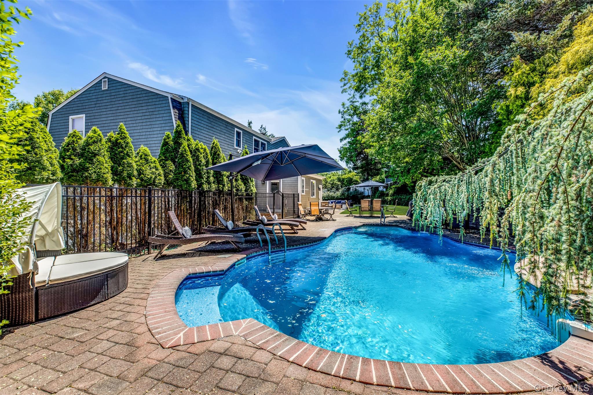345 Colonial Road Southold, NY 11971 - Photo 32 of 43 a view of a swimming pool with a patio