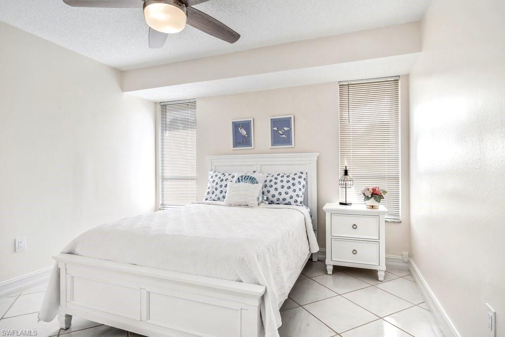 1207 Hernando Street Naples, FL 34103 - Photo 26 of 37 a bedroom with a bed and a cabinets