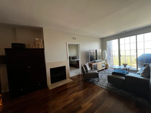 a living room with furniture flat screen tv and a fireplace