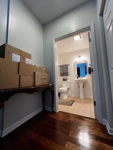 a view of a living room and kitchen with furniture and wooden floor