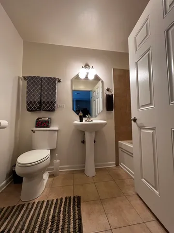 a bathroom with a sink a toilet and mirror
