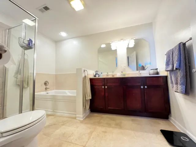 a bathroom with a bathtub shower sink and toilet