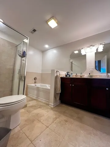 a bathroom with a sink vanity mirror and toilet
