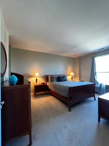 a bedroom with furniture and a lamp