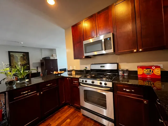 a kitchen with stainless steel appliances a stove and a microwave