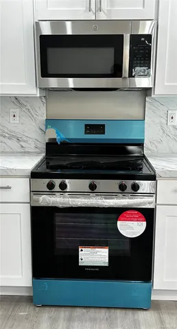 a stove top oven sitting inside of a kitchen