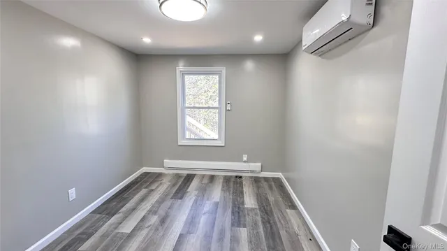 a view of room with window and wooden floor