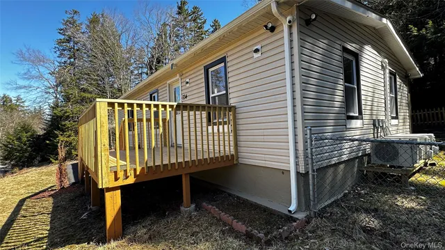 a view of a house with a yard and wooden fence