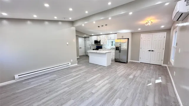a view of kitchen with cabinets and wooden floor