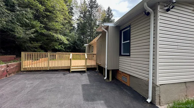 a view of a house with a backyard and stairs