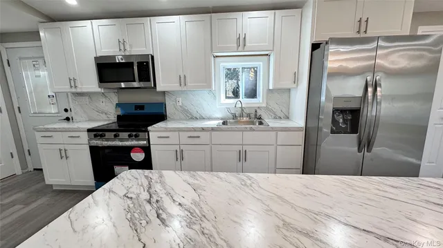 a kitchen with a refrigerator stove and sink