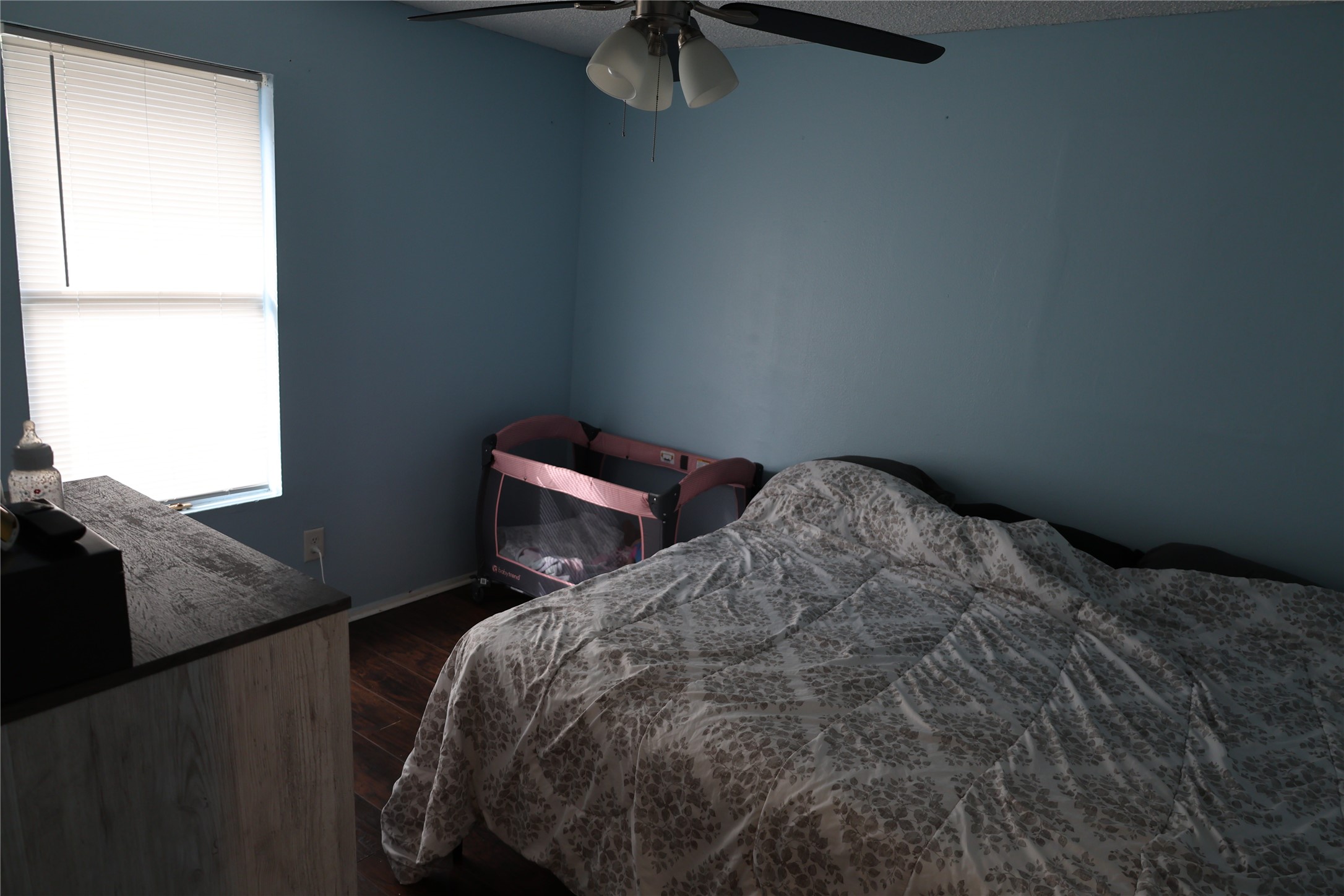 1009 Caplin Street Houston, TX 77022 - Photo 11 of 24 a bed sitting in a bedroom next to a window