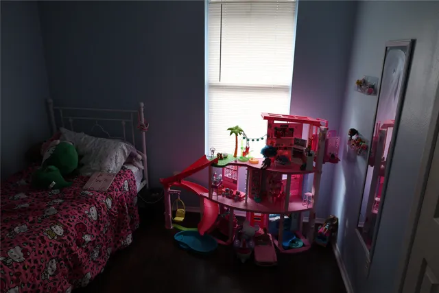 a bed sitting in a bedroom next to a window