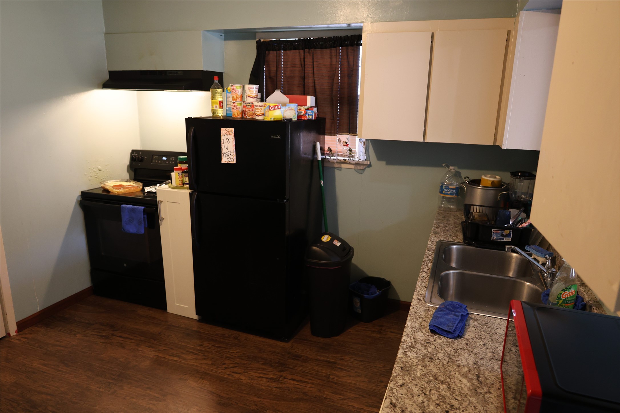 1009 Caplin Street Houston, TX 77022 - Photo 19 of 24 a room with water heater and wooden floor