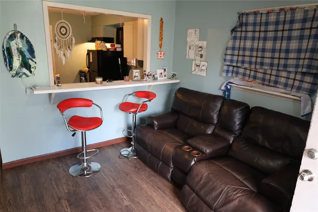 a living room with furniture and a lamp