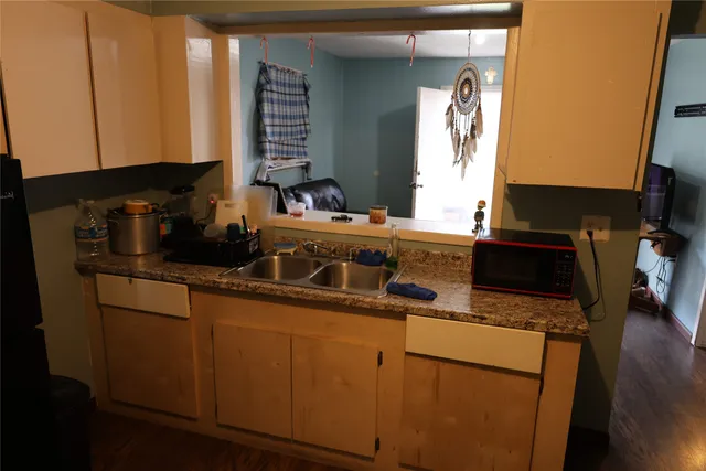 a kitchen with a sink a stove and cabinets