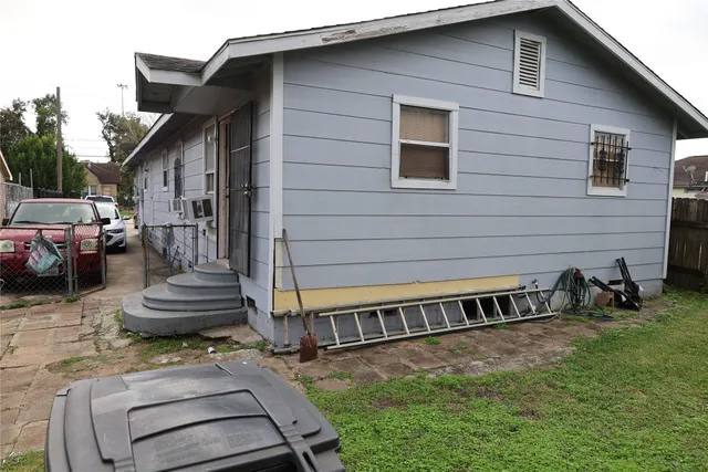 a view of a house with a yard chairs and stairs