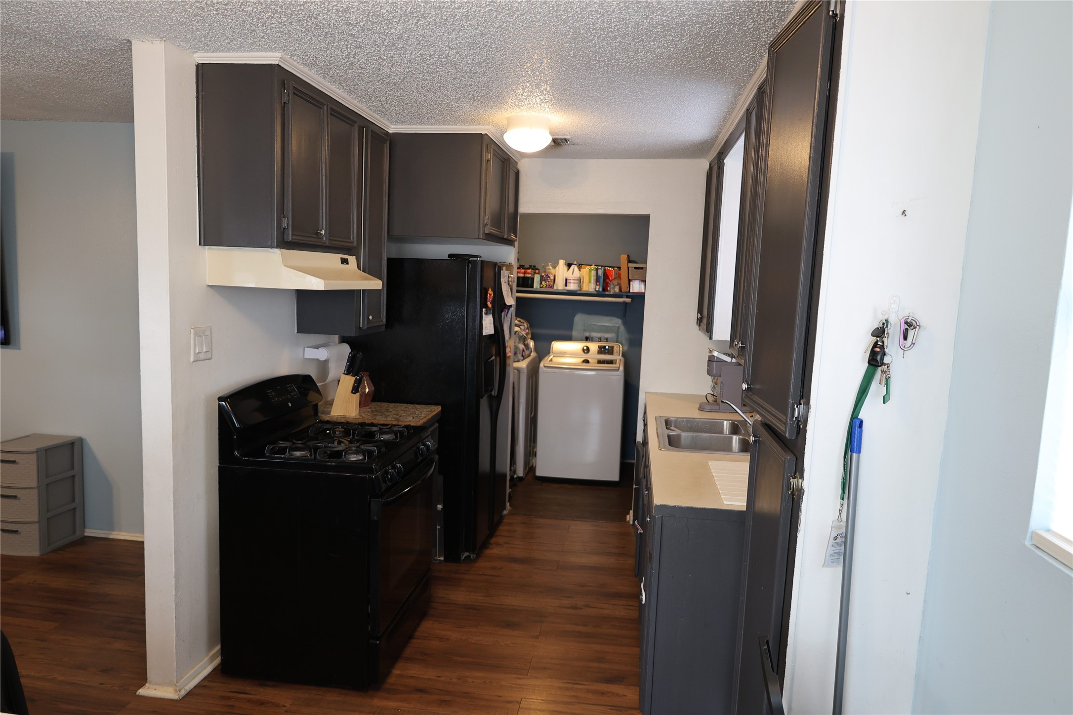 1009 Caplin Street Houston, TX 77022 - Photo 3 of 24 a kitchen with stainless steel appliances granite countertop a refrigerator a stove top oven a sink and dishwasher