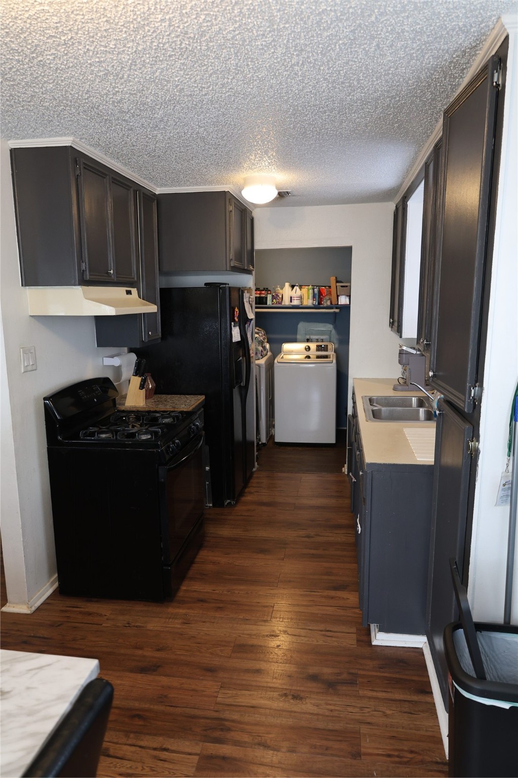 1009 Caplin Street Houston, TX 77022 - Photo 4 of 24 a kitchen with a refrigerator and a stove top oven
