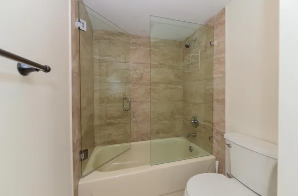 a bathroom with a shower and a toilet