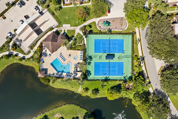 an aerial view of a house with swimming pool and outdoor seating