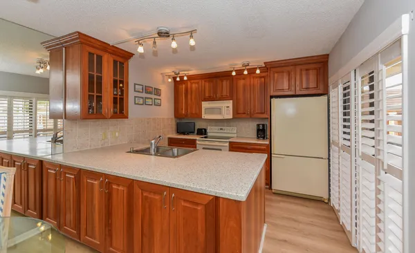 a kitchen with stainless steel appliances a refrigerator sink and cabinets
