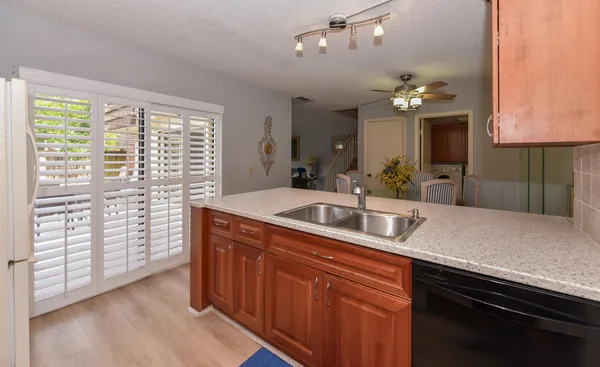 a kitchen with sink cabinets and chandelier