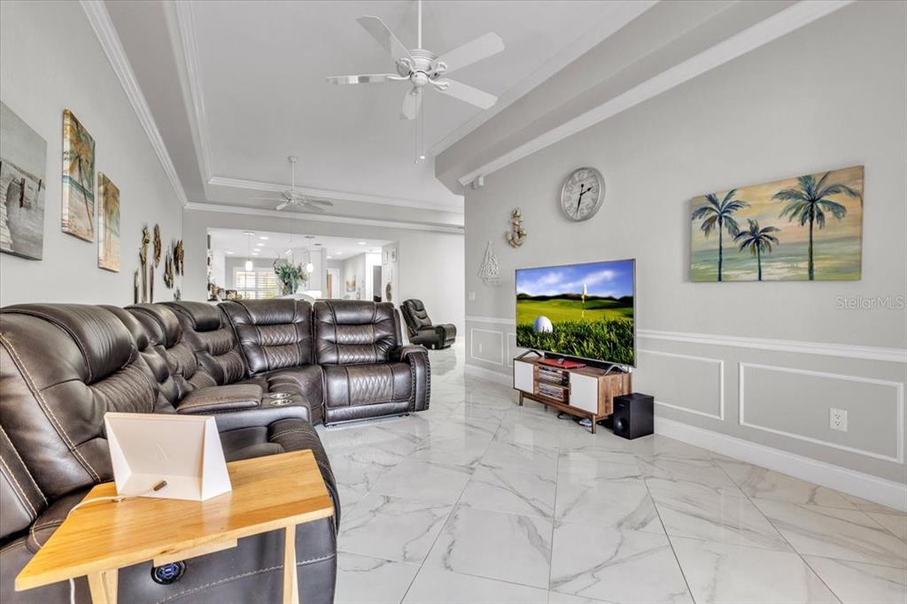1260 Rio De Janeiro Avenue, Unit 102 Punta Gorda, FL 33983 - Photo 10 of 46 a living room with furniture and a flat screen tv