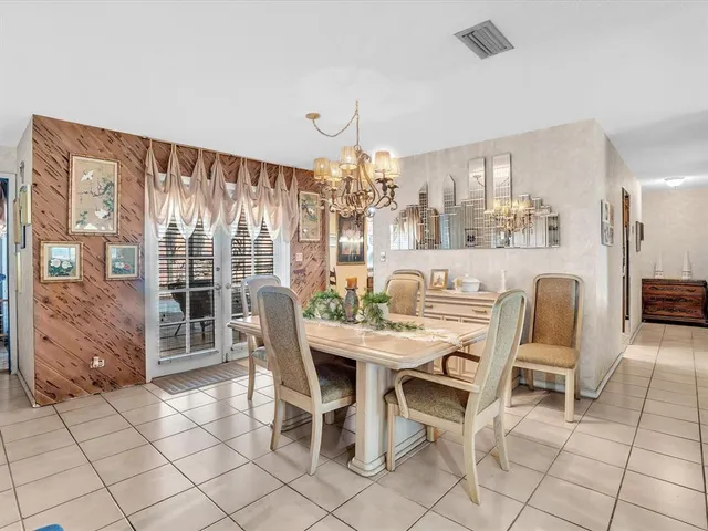 a view of a dining room with furniture large windows and wooden floor