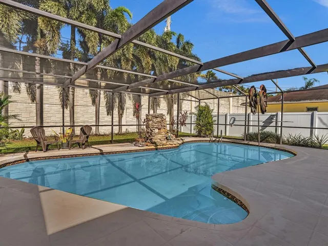 a view of a backyard with wooden fence