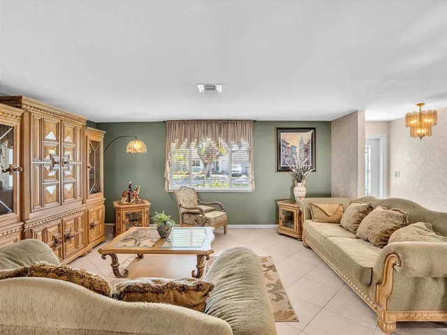 a living room with furniture and large windows