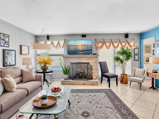 a living room with furniture a rug and a fireplace