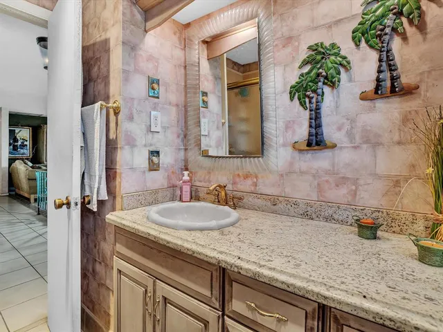 a bathroom with a glass door shower and a mirror
