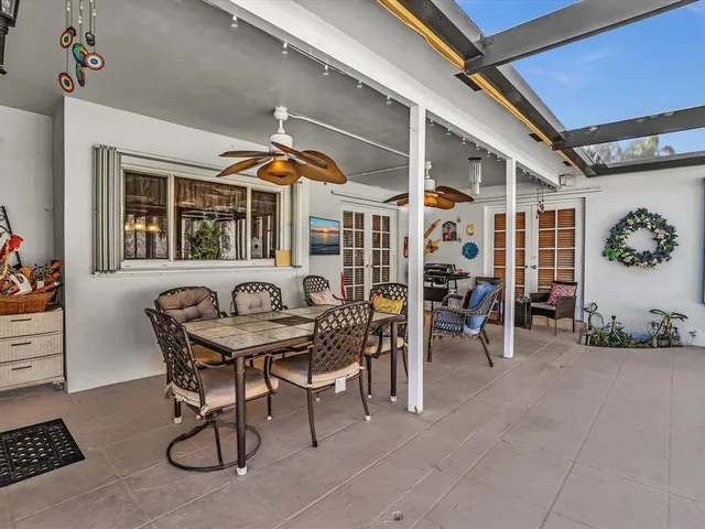 a living room with furniture a rug and a floor to ceiling window