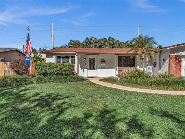 a dining room with furniture and a potted plant