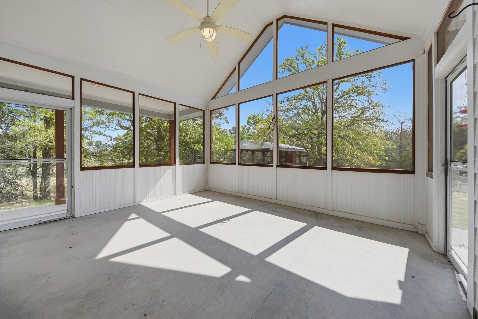 350 Owl Creek Road Giddings, TX 78942 - Photo 9 of 29 Unfurnished sunroom with ceiling fan