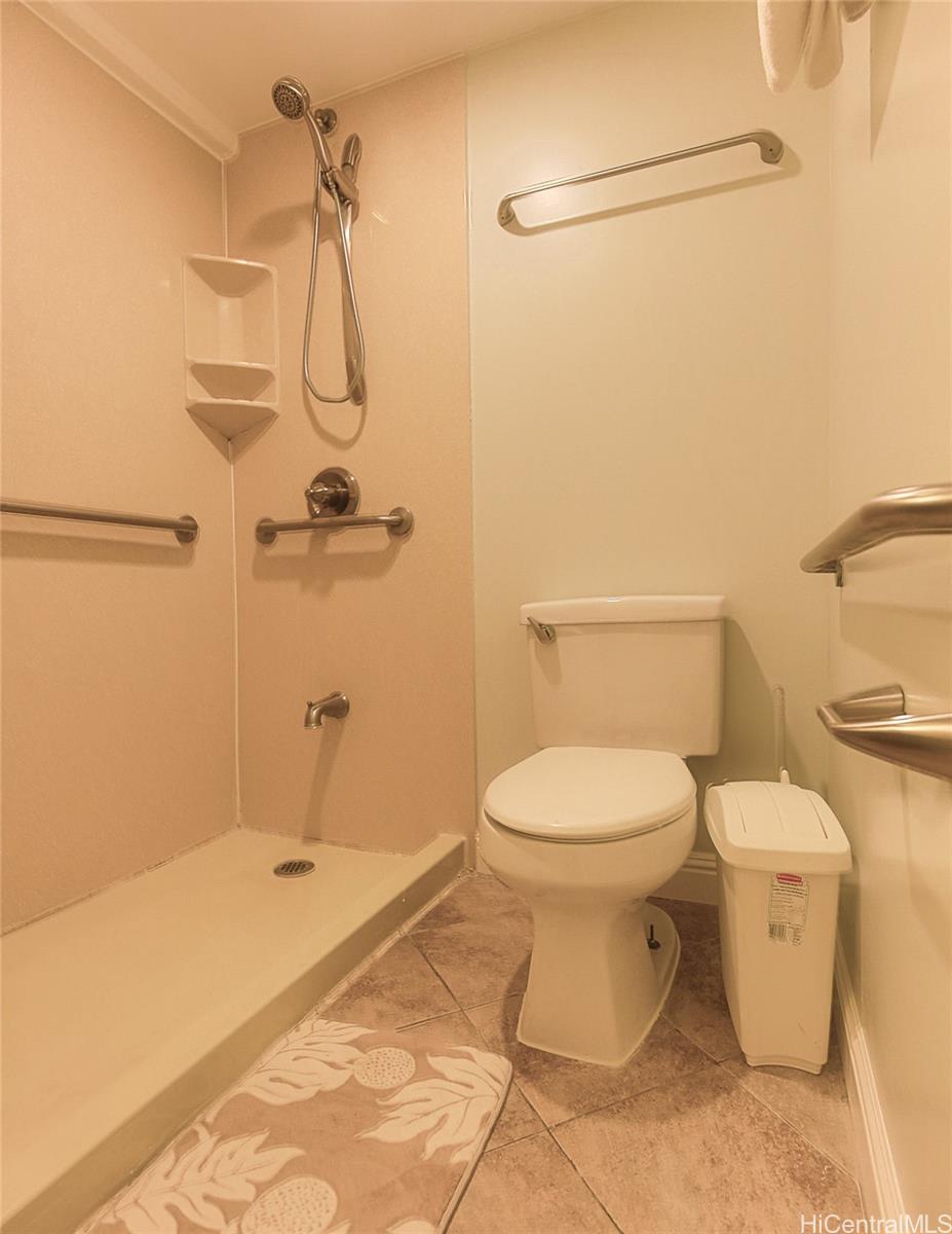 1690 Ala Moana Boulevard, Unit 1105 Honolulu, HI 96815 - Photo 11 of 13 a bathroom with a toilet sink and shower