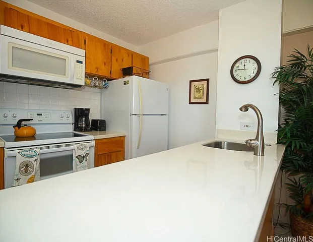 a kitchen with stainless steel appliances granite countertop a stove a refrigerator and a microwave