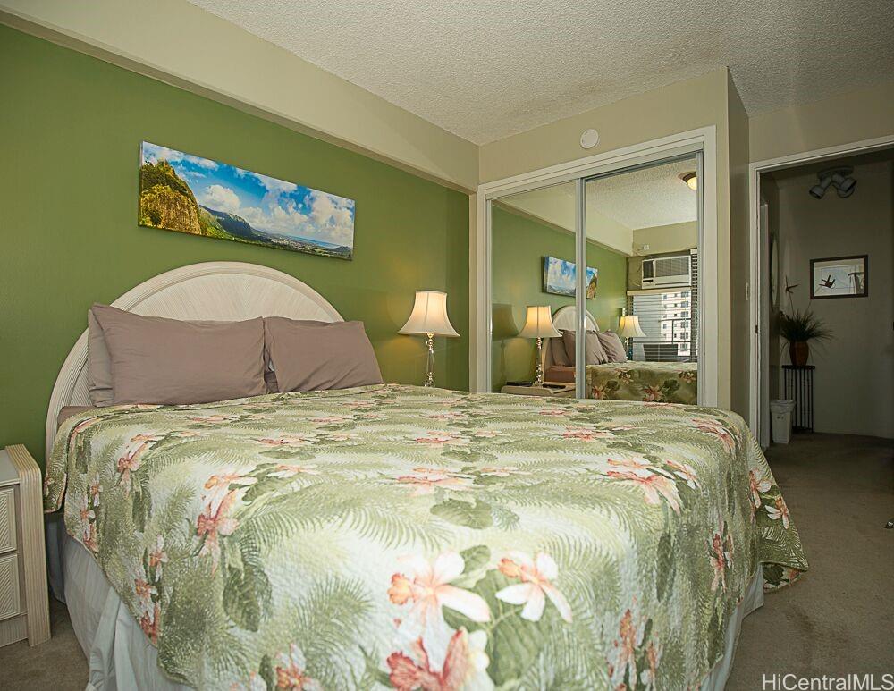 1690 Ala Moana Boulevard, Unit 1105 Honolulu, HI 96815 - Photo 8 of 13 a bedroom with a bed and painting on the wall