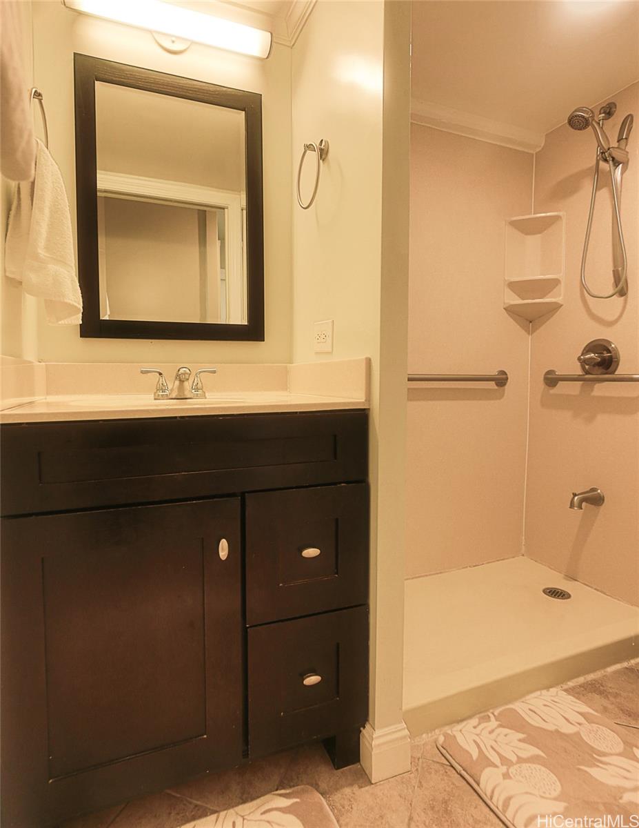 1690 Ala Moana Boulevard, Unit 1105 Honolulu, HI 96815 - Photo 10 of 13 a bathroom with a sink and a mirror