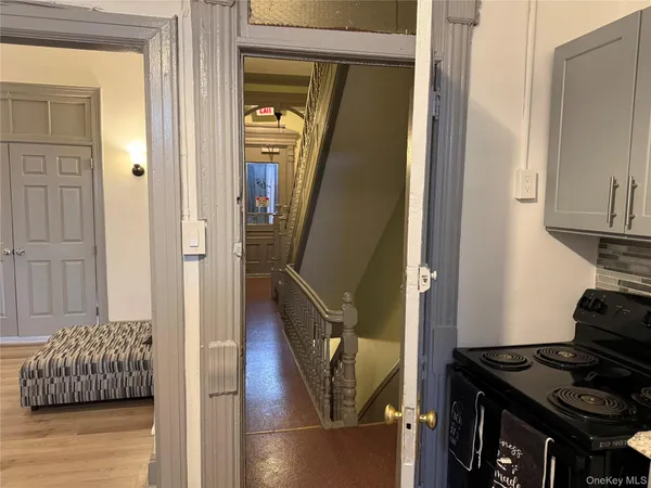 a view of hallway with furniture and stairs