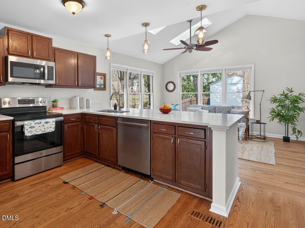212 Old Fox Trail Durham, NC 27713 - Photo 2 of 35 a kitchen with stainless steel appliances granite countertop a sink a stove and a wooden floors