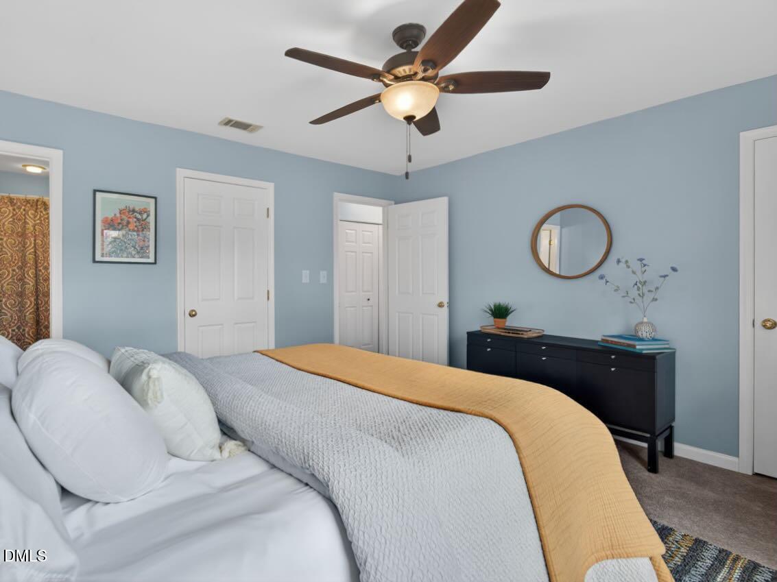 212 Old Fox Trail Durham, NC 27713 - Photo 21 of 35 a bedroom with a bed and a chandelier