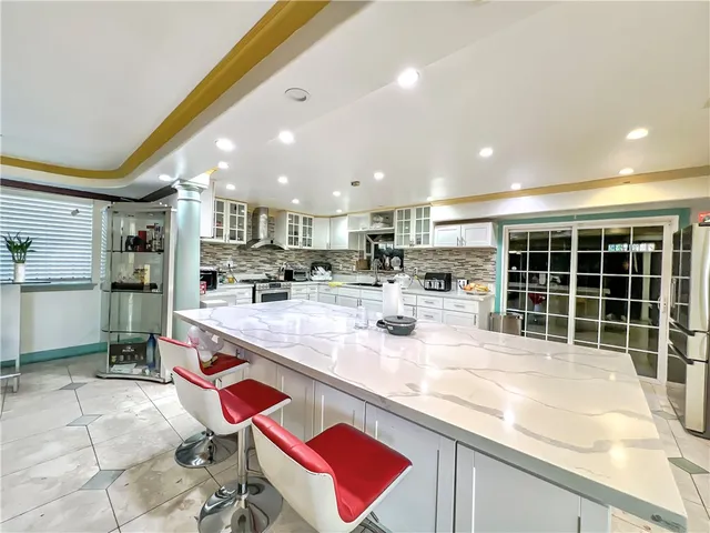 a kitchen with stainless steel appliances granite countertop a sink and cabinets