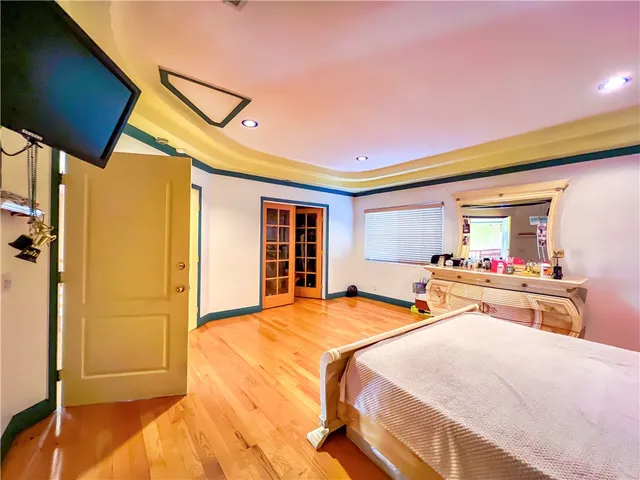 a bedroom with a bed dresser and a window