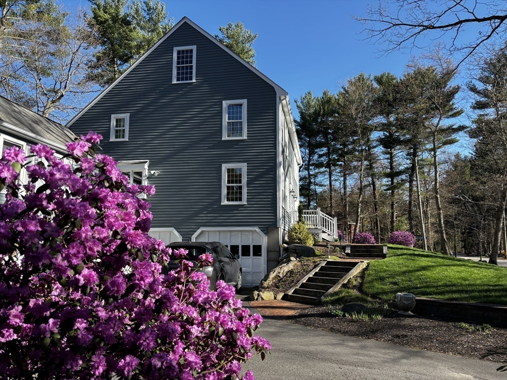 142 Baker Street Walpole, MA 02081 - Photo 1 of 42 a front view of a house with a yard
