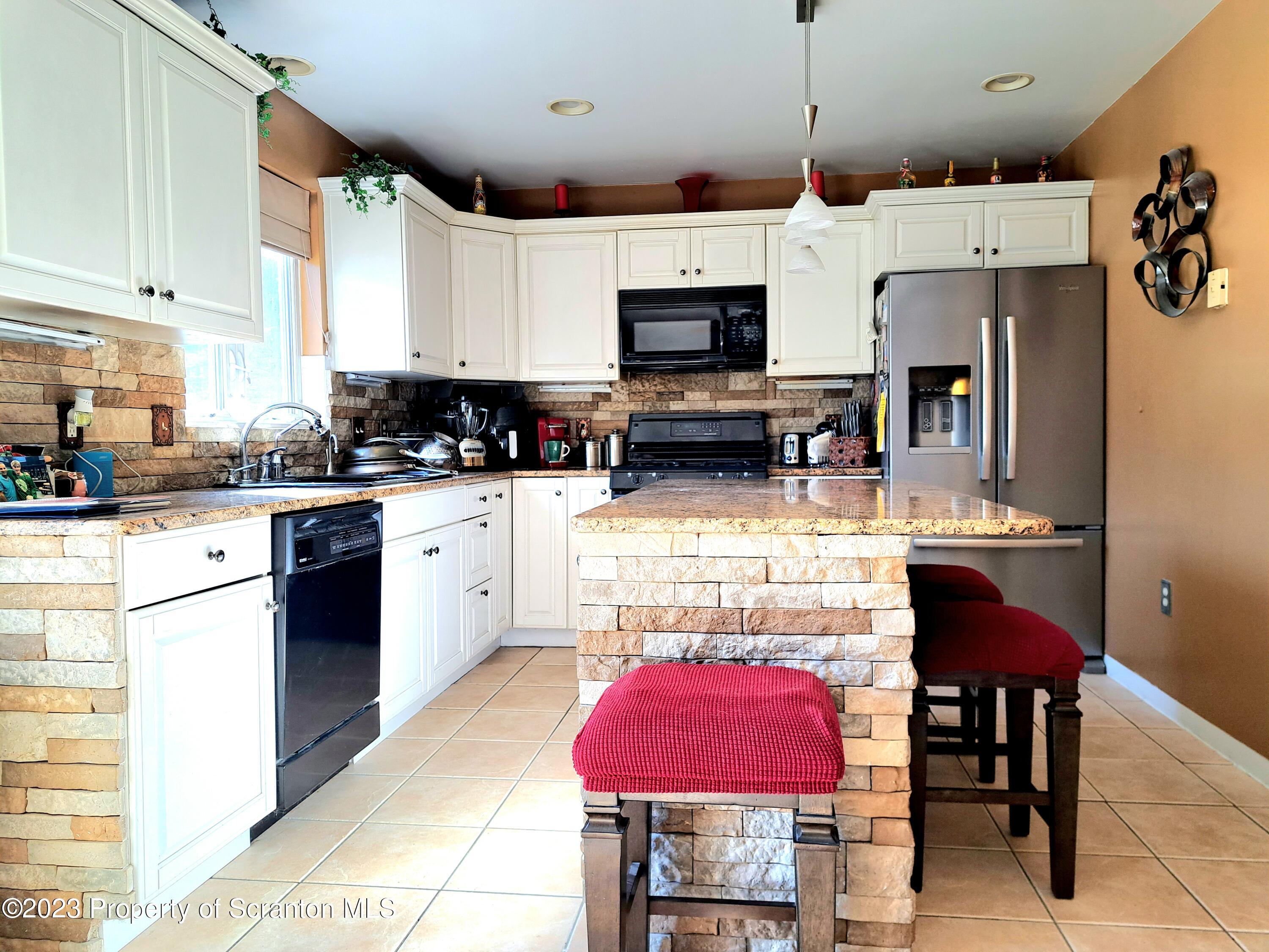 987 Chase Road Shavertown, PA 18708 - Photo 11 of 70 a kitchen with stainless steel appliances kitchen island granite countertop a sink and cabinets