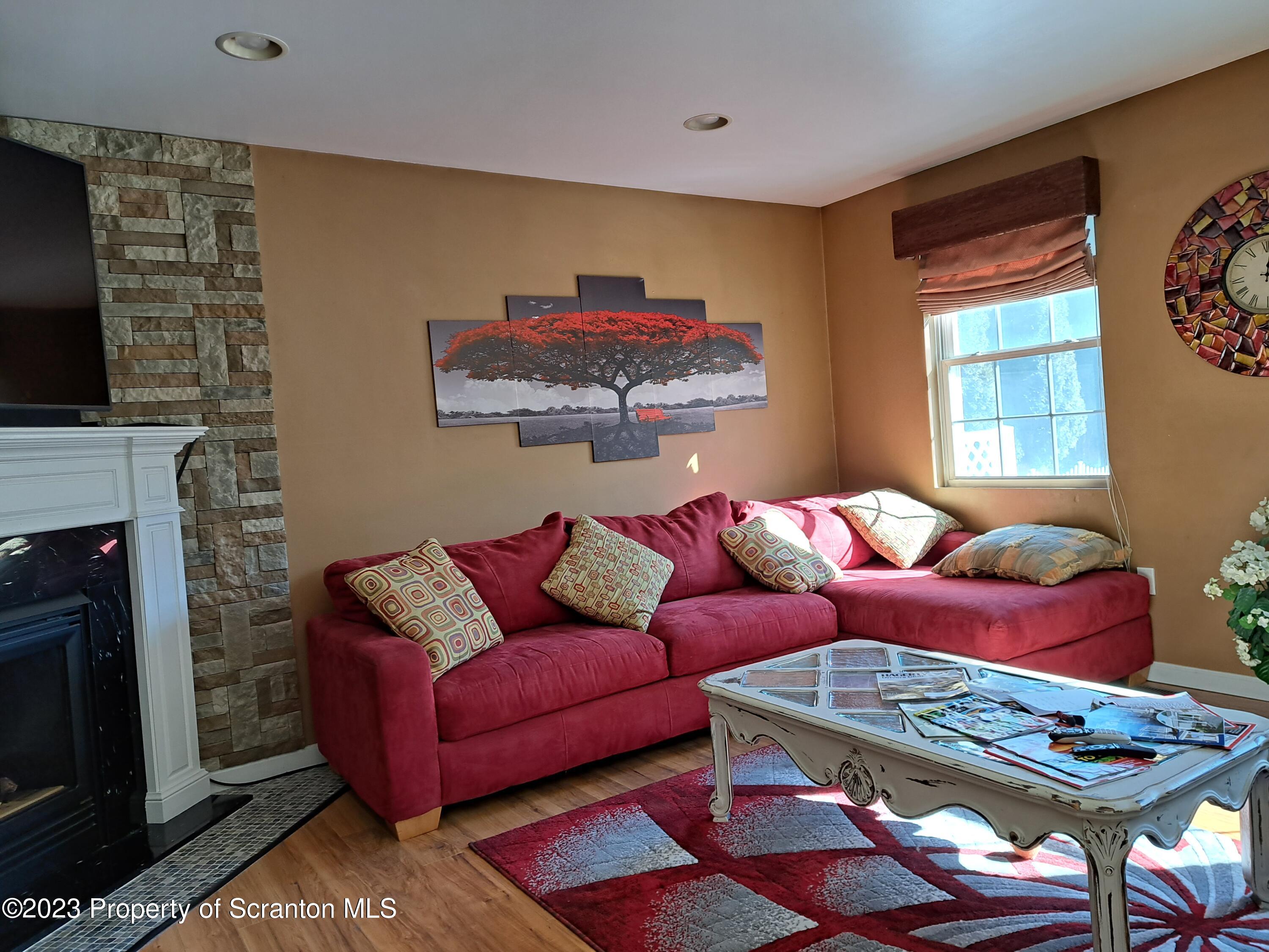 987 Chase Road Shavertown, PA 18708 - Photo 23 of 70 a living room with furniture fireplace and window