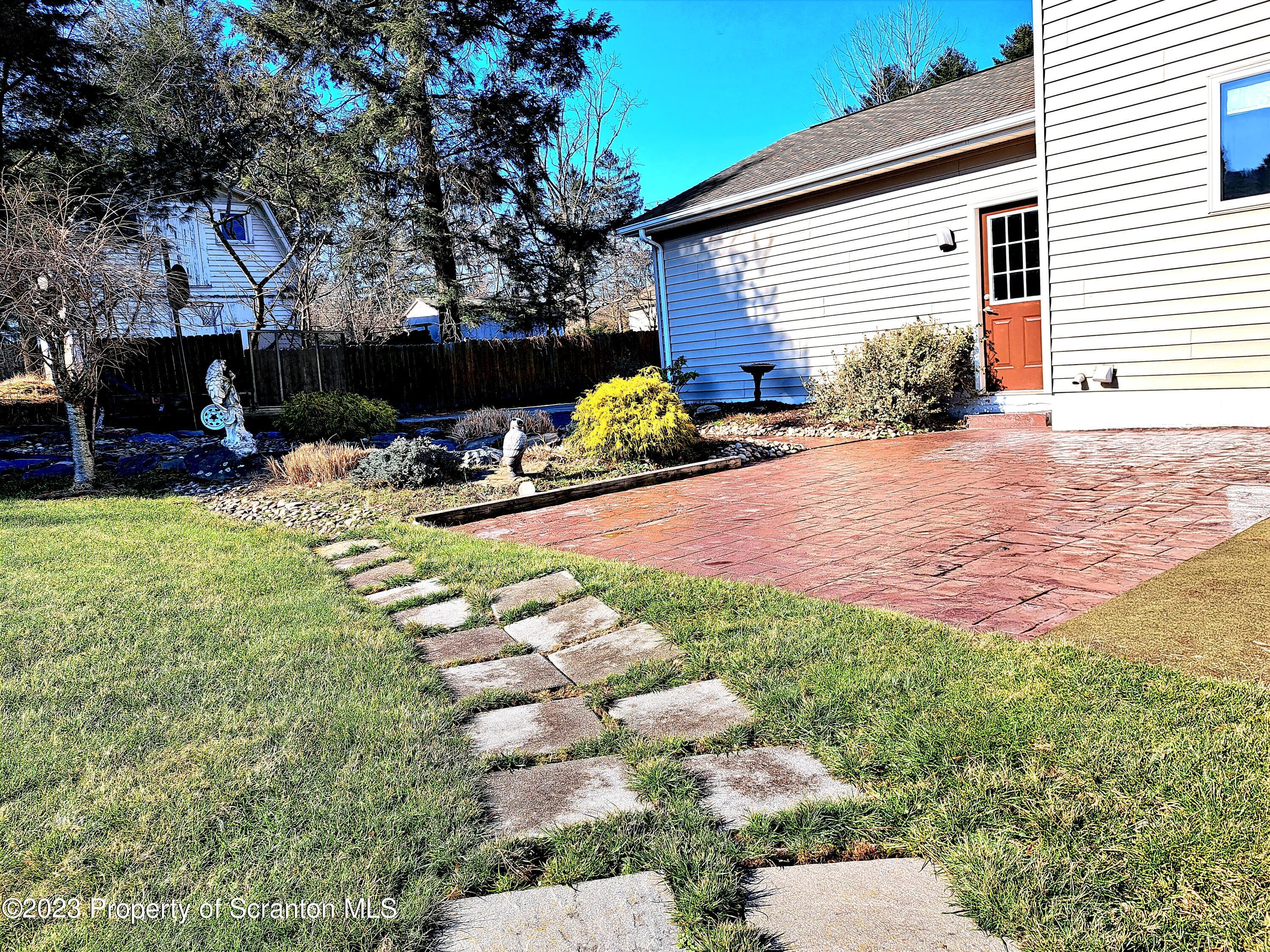 987 Chase Road Shavertown, PA 18708 - Photo 4 of 70 a view of a backyard with table and chairs potted plants and a large tree