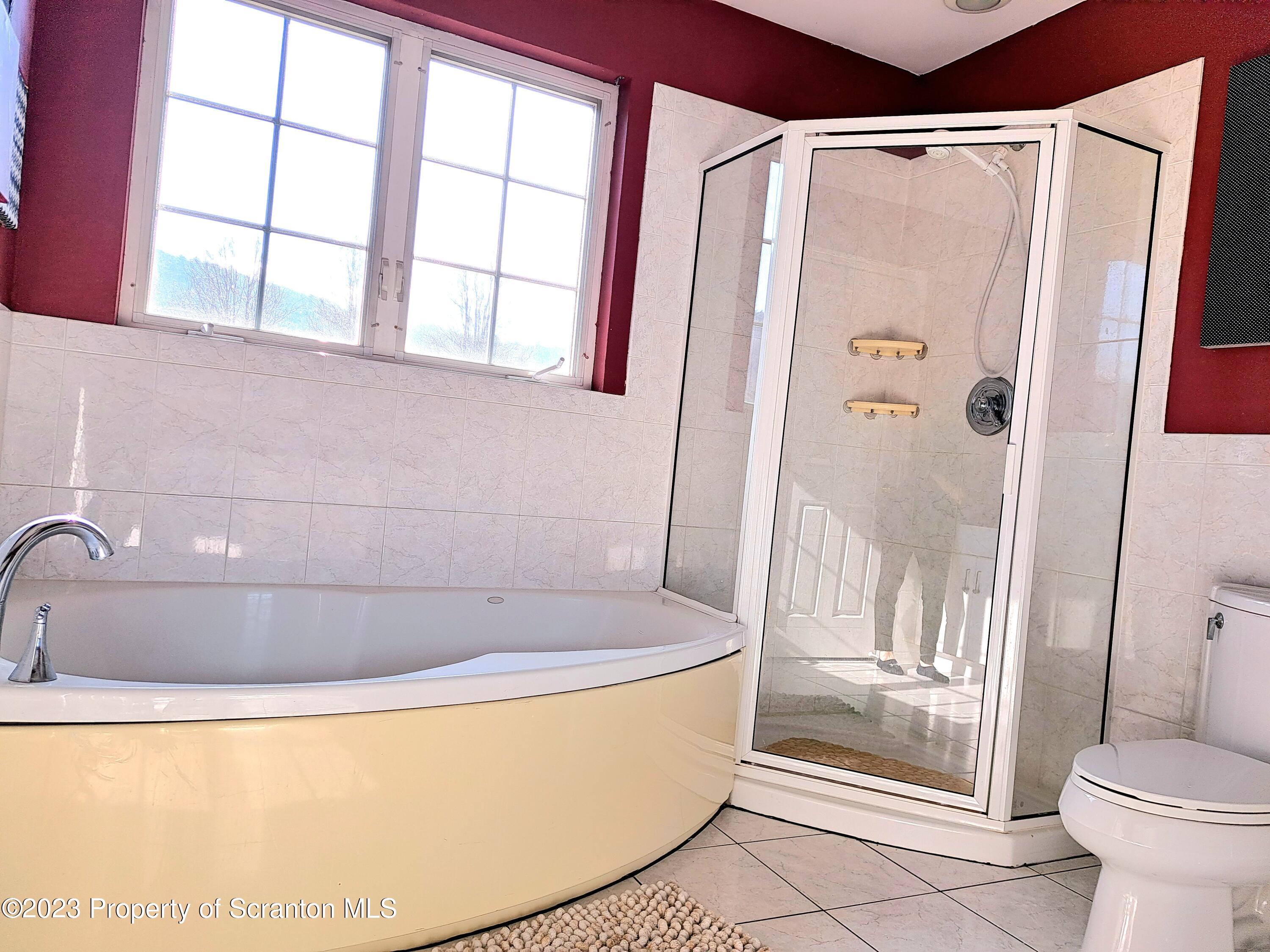 987 Chase Road Shavertown, PA 18708 - Photo 43 of 70 a bathroom with a bathtub and a shower